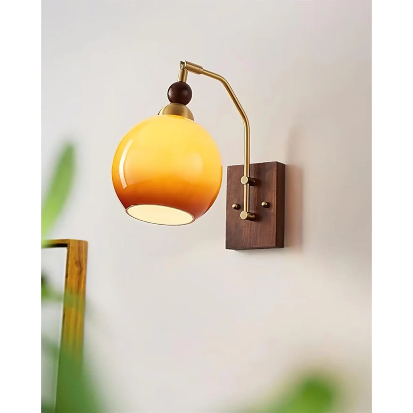 Elegant Wall Sconce Lighting with Caramel Glass Shade and Adjustable Arm for Modern Interiors